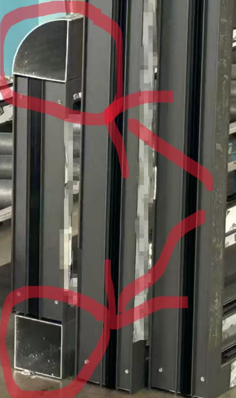 An assembled window frame, with the areas that carry no thermal break circled by hand in red
