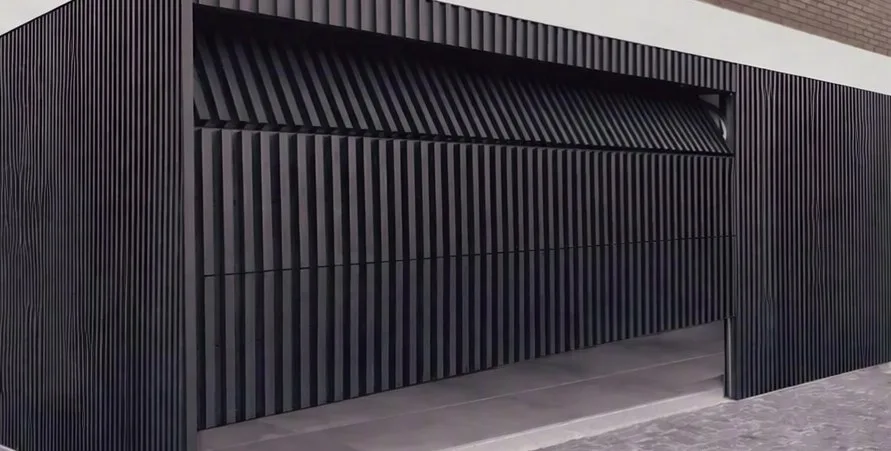 Black slatted aluminium sectional garage door on a modern facade